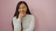 © Krakenimages.com - Woman smiling confidently against an isolated pink background, illustrating asian beauty and style with a focus on a young, attractive chinese female adult.