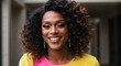 © Andrey - black trans woman smiling with curly hair wearing colorful outfit outdoors