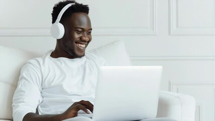Poster - Man sitting on couch with laptop and headphones, perfect for remote work or study illustrations