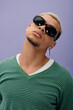 © Bliss - Stylish young african american man with dyed hair poses confidently in trendy outfit