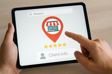 Poster - Hand holding tablet searching for store location and client information image