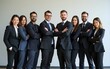 © wu - a show of unity, a row of Caucasian businesspeople poses for a group photo, showcasing their collective vision for the successful business corporation. generative AI. High quality