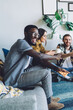 © BullRun - Multiracial adult people worrying about friends playing video game together
