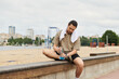 © LIGHTFIELD STUDIOS - Young sporty man stretches and prepares for outdoor workout by the beach