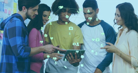 Poster - Team members collaborating around tablet in studio, visualizing network icons with whiteboard notes