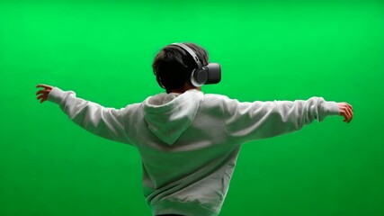 Poster - Person wearing VR headset, arms outstretched against green screen.