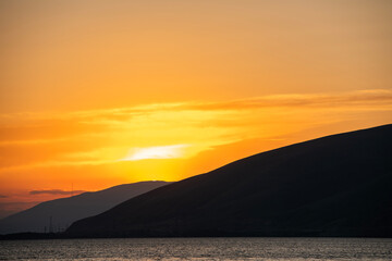 Wall Mural - Beautiful sunset with clouds over the lake.