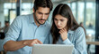 © Ada - Checking business solutions, Two young professionals, a man and a woman, are closely collaborating and looking at a laptop screen in a modern office or co-working space.