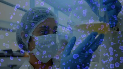 Aufkleber - Science lab technician manipulating flask under purple overlay appearing for assessing clarity