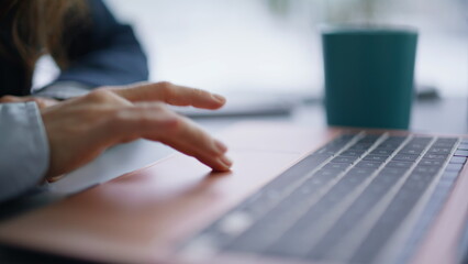 Wall Mural - Woman hands using touchpad laptop at workplace closeup. Finger touching computer