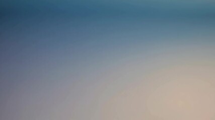 Wall Mural - Dreamy abstract blur with fine grain detail, smooth gradient transitioning from sky blue to pale orange