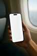 © CasalDesign - person holding smartphone with white screen on plane