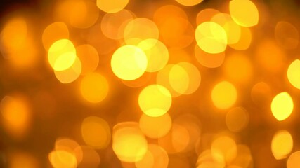 Poster - Abstract warm golden bokeh lights with gentle, fluctuating movement creating a festive and celebratory background effect in a video footage.