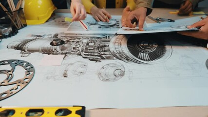 Poster - A group of professionals collaborates around a table filled with technical schematics of a jet engine design. They discuss ideas and analyze various components. SACTR