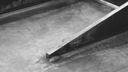 Poster - weld seam attaches a black metal part to another metal surface, metal welding industrial reliability and strength concept background