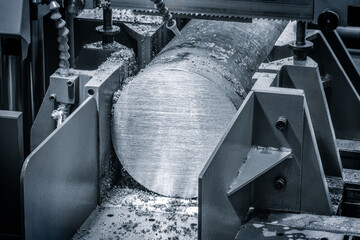 Poster - Industrial band saw cutting large metal part with round cross-section industrial concept background