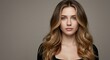 © Arx PhotoStock - Portrait of a Woman with Long Wavy Brown Hair on a Gray Background