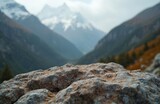 Close-up rock surface mountains. Blurred background mountain landscape with snow peaks, green slopes, valley. Scenic outdoor nature. Ideal for product display background. Promote travel, adventure, Close-up rock surface mountains. Blurred background mountain landscape with snow peaks, green slopes, valley. Scenic outdoor nature. Ideal for product display background. Promote travel, adventure,