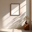 © Aurora frame - A wooden framed mockup poster hangs on a beige wall in a sunlit room