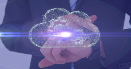 Poster - Holding businessman in dark suit presenting floating holographic cloud icon in office, gear motifs