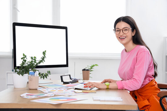 Female designer working with blank computer in office