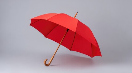 Poster - Bright Red Umbrella with Wooden Handle on Gray Background, Ideal for Weather Protection, Fashion Accessories, and Outdoor Events Imagery