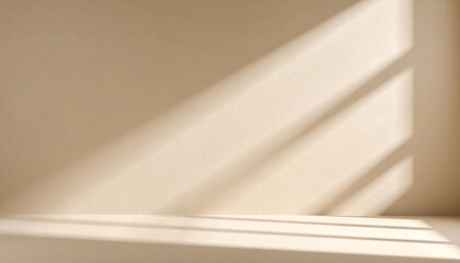 Poster - Soft light casts gentle shadows on a minimalist beige wall, creating a serene and calming atmosphere