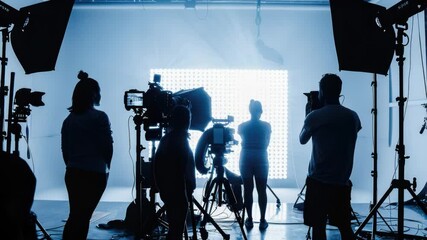 Poster - A group of people posing in front of a camera, studio lighting and equipment