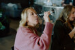 © Cavan Images - Woman tasting wine at restaurant with friends