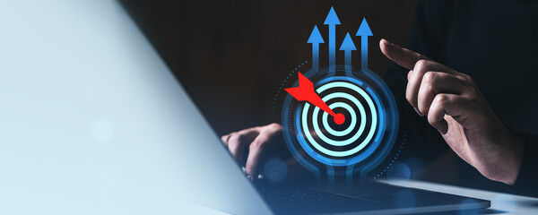 Poster - Business goal achievement concept with digital target and arrow interface on laptop screen in futuristic workspace environment for success strategy.