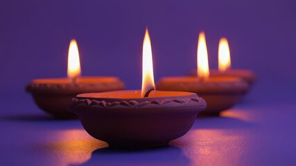 Poster - A row of three lit candles on a deep purple background