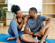 © Lumos sp - Young african american couple exrcising and having fun fitness mat floor at home