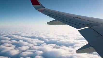 Poster - Airplane wing gliding through expansive blue sky, revealing stunning cloudscape with fluffy white clouds stretching across panoramic aerial perspective during daytime flight