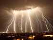 © Tiramisu - Dramatic view of multiple lightning strikes over illuminated cityscape