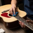 © Muniba - Person cleaning wooden acoustic guitar with blue cloth