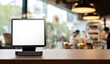 © Andy - Blank digital display sits on a counter in a blurred cafe background, ready for your message.