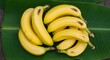 © Astri - Fresh yellow bananas on a vibrant green banana leaf. Healthy tropical fruit. Top view.