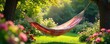 © Traitod - Sun-drenched hammock sways gently in a breezy summer garden, overflowing with vibrant flowers and lush greenery Perfect for relaxation and escaping the heat , leisure, rest, lazy