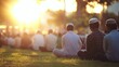© Afifah - A large group of people seated outdoors, likely at a religious gathering, in the golden hour sunlight