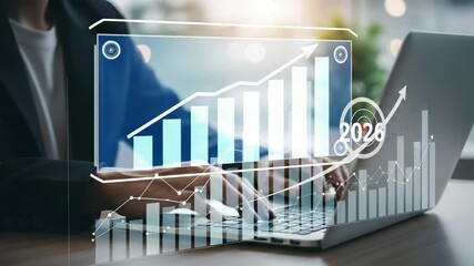 Leinwandbilder - Person typing on laptop with overlayed financial charts and target for the year of twenty twenty six