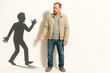 © Andbiz - A man argues with his own shadow. Space for text.