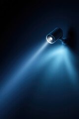 Poster - Spotlight beam creates dramatic lighting effect in a dark space at night