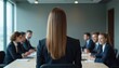 © Pete - Businesswoman speaking meeting. Woman back facing camera. Colleagues in suits listen attentively. Leadership concept. Office interior, teamwork, company discussion. Confident, pro, elegant. Team