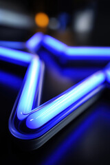 Poster - Bright blue neon star shape glowing on a dark surface at night