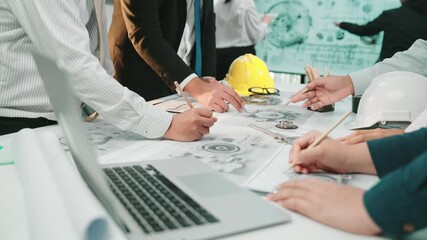 Poster - A diverse team of professionals engaging in dynamic discussions while analyzing technical drawings and blueprints on a modern office table, showcasing collaboration and innovation. SACTR
