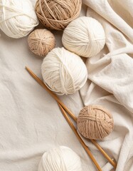 Poster - Soft white blanket with cozy ball of yarn and knitting needles on warm linen background