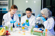 © laddawan - Team of scientists examining food samples in a lab with microscopes. Perfect for themes of food science, biotechnology,