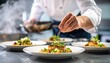 © ArtNote - A chef meticulously garnishes a beautifully plated dish with fresh herbs in a professional kitchen setting, showcasing culinary artistry.