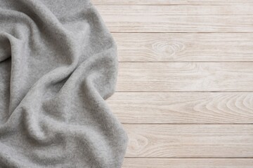 Poster - Gray wool fabric displayed on a rustic wooden surface