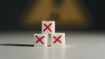 Poster - Sugar cubes marked with red crosses symbolizing health dangers, highlighting risks of excessive sugar consumption against blurred warning background